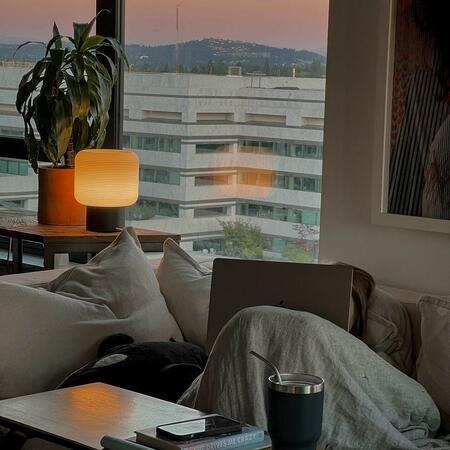 Gantri lamp on a table with a city view