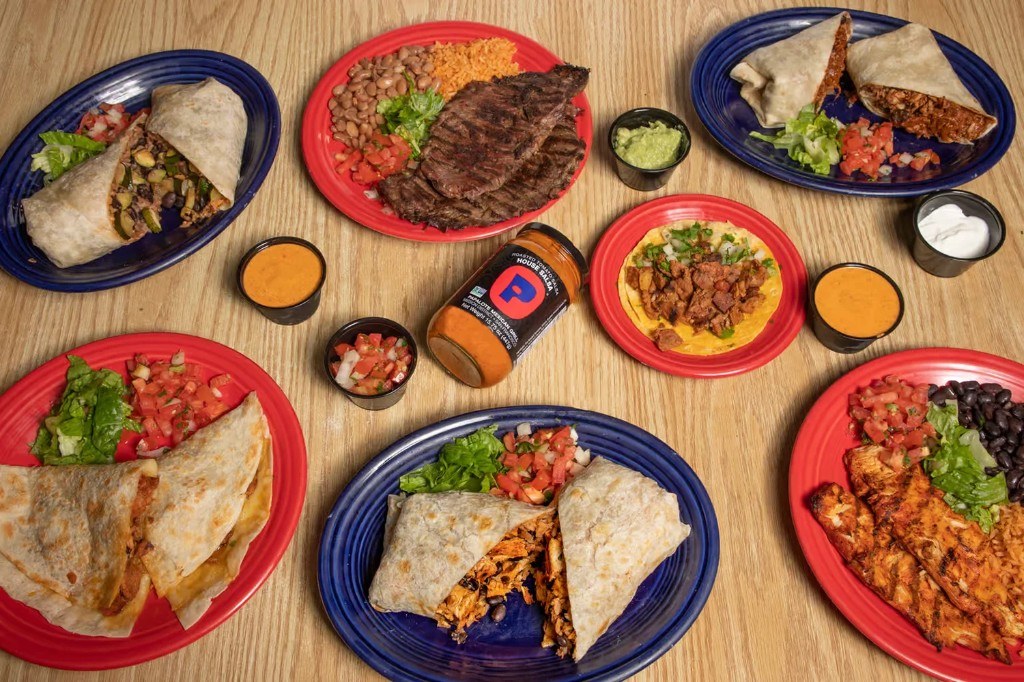 Spread of Papalote dishes with a jar of house salsa