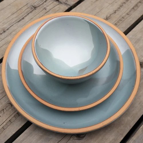 Stacked Sven plates and bowl with tan rims